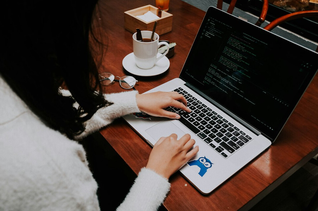 person learning to code on laptop